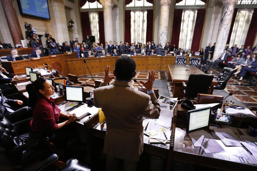 Los Angeles City Council President Herb Wesson, center, speaks at Los Angeles City Hall before the City Council voted on an ordinance to raise the minimum wage in Los Angeles to $15 per hour by 2020.