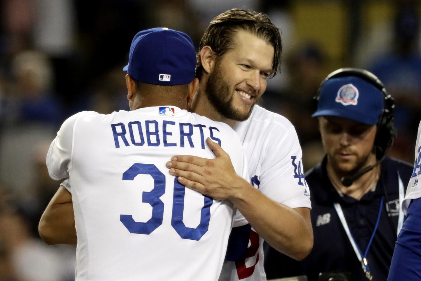 Clayton Kershaw embraces Dodgers manager Dave Roberts after pitching eight shutout innings in 3-0 win over the Braves in Game 2 of their 2018 NLDS series.