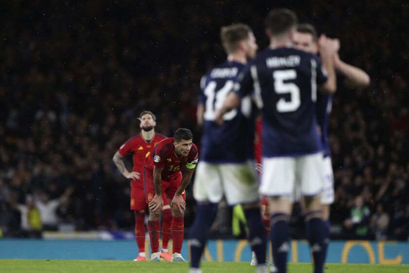 Spain's Rodri, second from left, reacts at the end of the Euro 2024 group A qualifying soccer match between Scotland and Spain at the Hampden Park stadium in Glasgow, Scotland, Tuesday, March 28, 2023. Scotland won 2-0. (AP Photo/Scott Heppell)