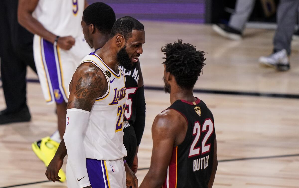 Lakers forward LeBron James and Heat star Jimmy Butler exchange some words during Game 3 of the NBA Finals on Sunday night.