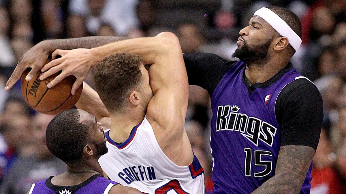 Clippers forward Blake Griffin is fouled by Kings center DeMarcus Cousins during a game on Nov. 23, 2013.