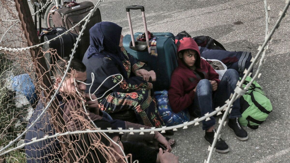 Palestinians in the southern Gaza Strip wait to cross into Egypt through the Rafah border crossing after Egyptian authorities opened it Feb. 7 for humanitarian cases.