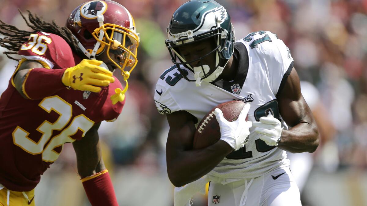 Eagles receiver Nelson Agholor gets past Redskins safety D.J. Swearinger during a 58-yard touchdown reception in the first half Sunday.