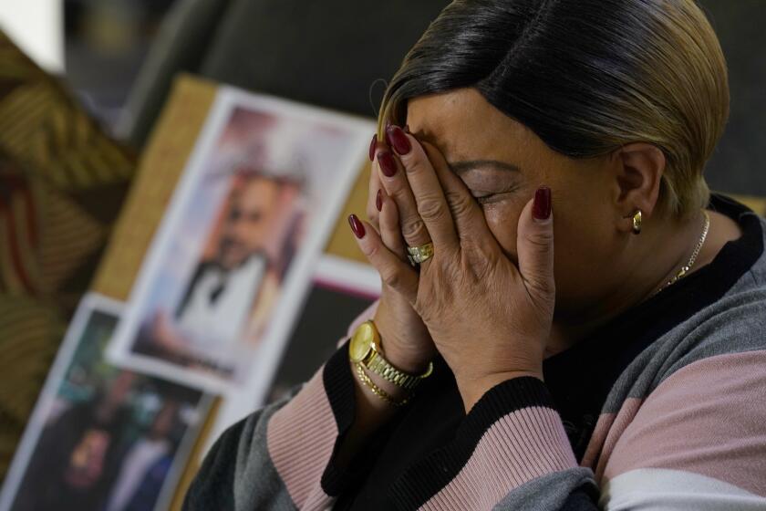 Penelope Scott holds her head in her hands as pauses for a moment as she talks about her son, De'vazia Turner, one of the victims killed in a mass shooting, during an interview with The Associate Press in Elk Grove, Calif., Monday, April 4, 2022. Multiple people were killed and injured in the shooting a day earlier. (AP Photo/Rich Pedroncelli)