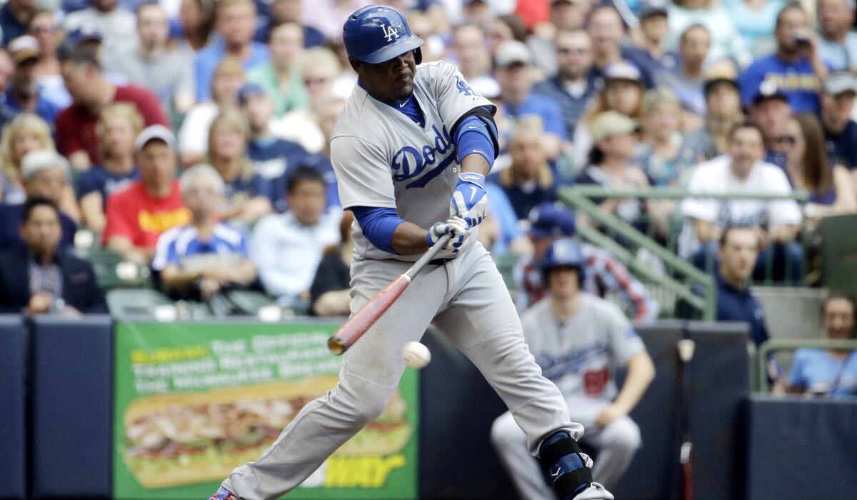 Los Angeles Dodgers' Juan Uribe hits an RBI single during a 14-4 win over the Milwaukee Brewers on Thursday.