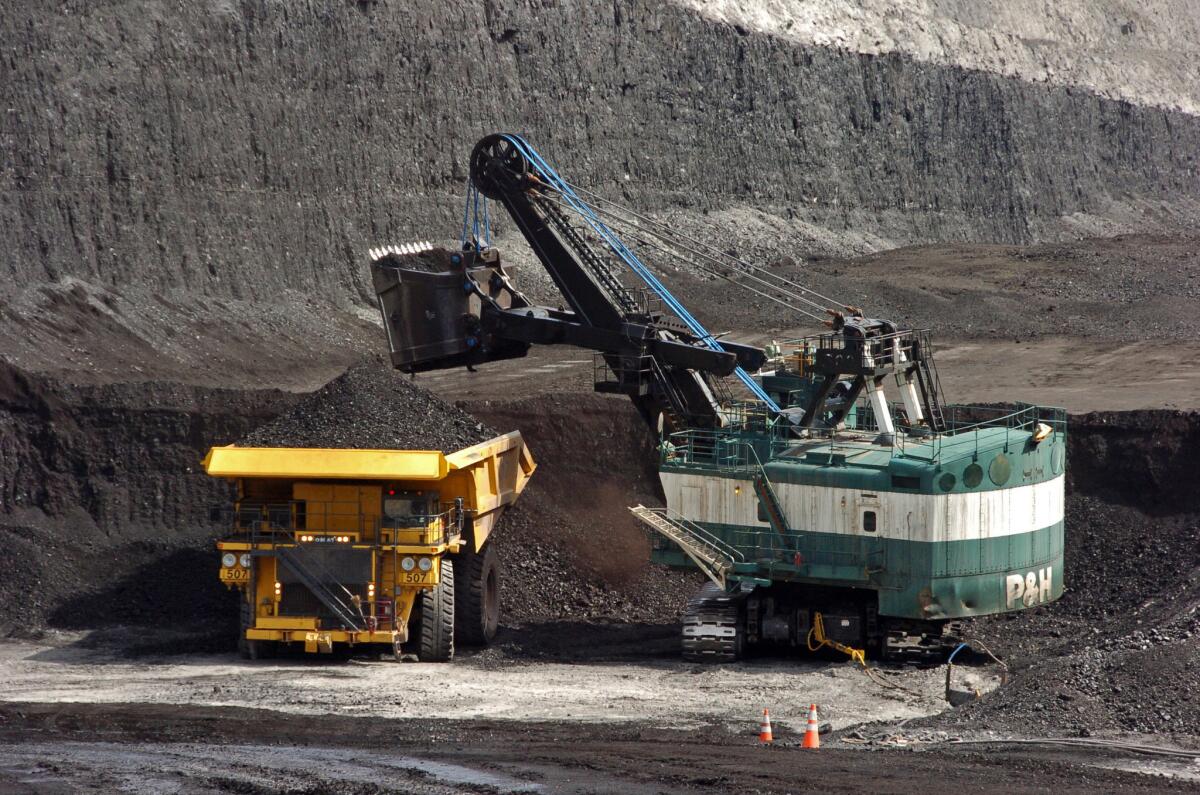 A machine loads coal onto a truck at a mine in Montana in 2013. A divided Supreme Court has agreed to halt enforcement of President Obama's plan to address climate change until after legal challenges are resolved.