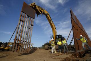 FILE - Construction crews install new border wall sections seen from Tijuana, Mexico., Jan. 9, 2019. An anti-immigration group scored a legal victory on Friday, Aug. 12, 2022, in its federal lawsuit arguing the Biden administration violated environmental law when it halted construction of the U.S. southern border wall and sought to undo other immigration policies by former President Donald Trump. (AP Photo/Gregory Bull, File)