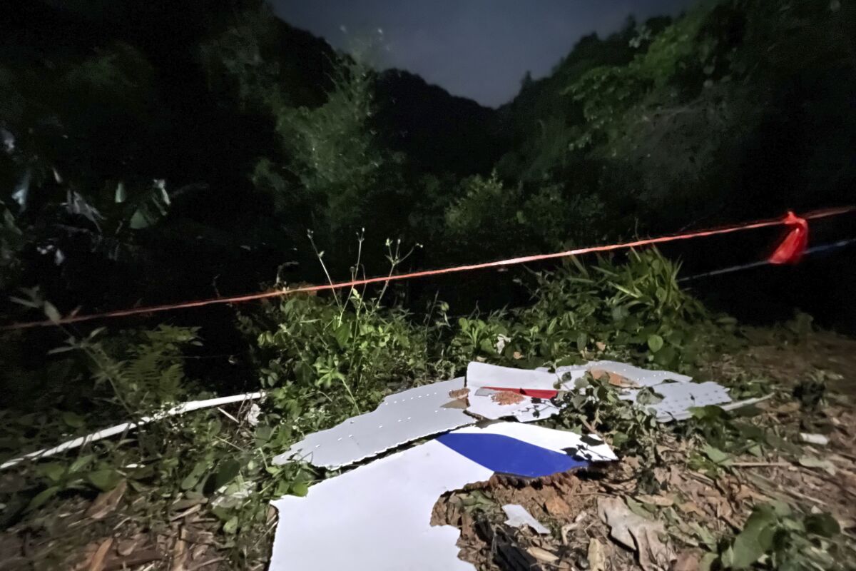 Debris is seen at the site of a plane crash in Tengxian County in southern China's Guangxi Zhuang Autonomous Region