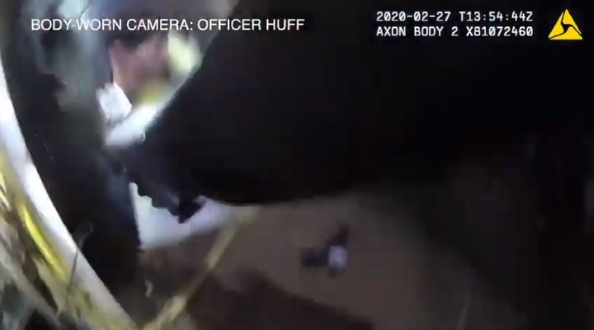 In this screenshot, body-worn camera footage from Officer Jeremy Huff shows the replica gun on the ground as Huff fires at Carlos Soto on Feb. 27 in Otay Mesa.