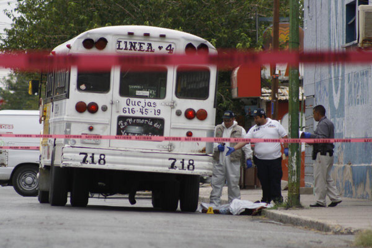 Forensic workers last month examine the scene where a bus driver was allegedly killed by a self-styled "bus driver hunter" in Ciudad Juarez, Mexico.