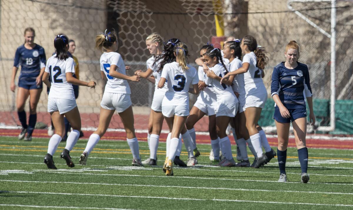 Newport Harbor's Stella Gaffney walks away as Pacifica celebrates a goal in a CIF Southern Section Division 1 playoff game.