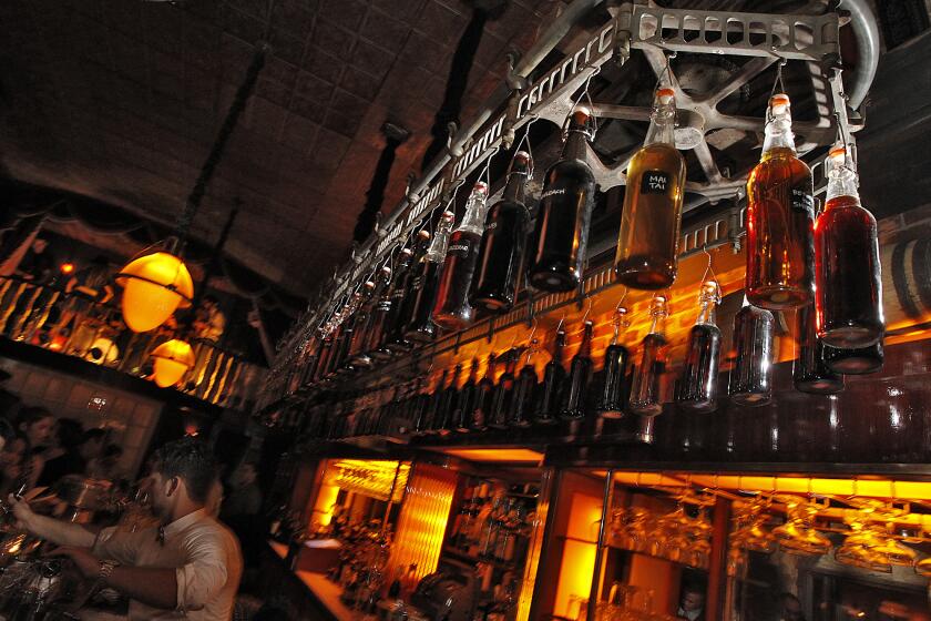 HOLLYWOOD, CA, WEDNESDAY, SEPTEMBER 12, 2012 -- Bottles hang from a rotating mechanism over the bar at Club Sassafras, a southern based bar built from a former townhouse imported from Savannah, Georgia. (Robert Gauthier/Los Angeles Times)
