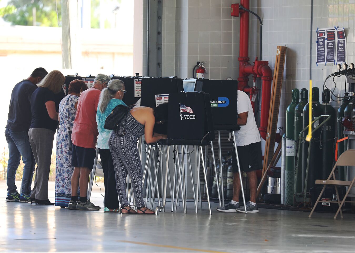 Voters cast their ballots at a polling station in a Hialeah, Fla., fire station.