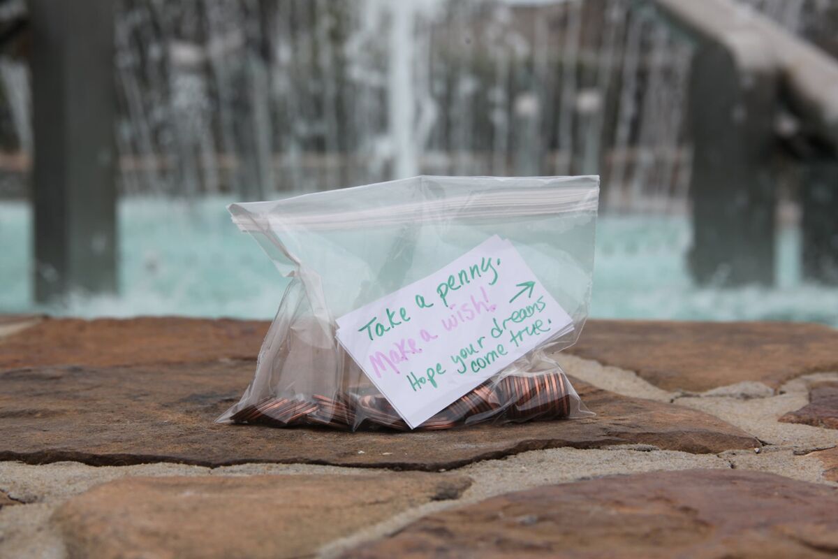 In this Nov. 20, 2020 photo, a bag containing pennies encourages passersby to make a wish  in Peachtree City, Ga.