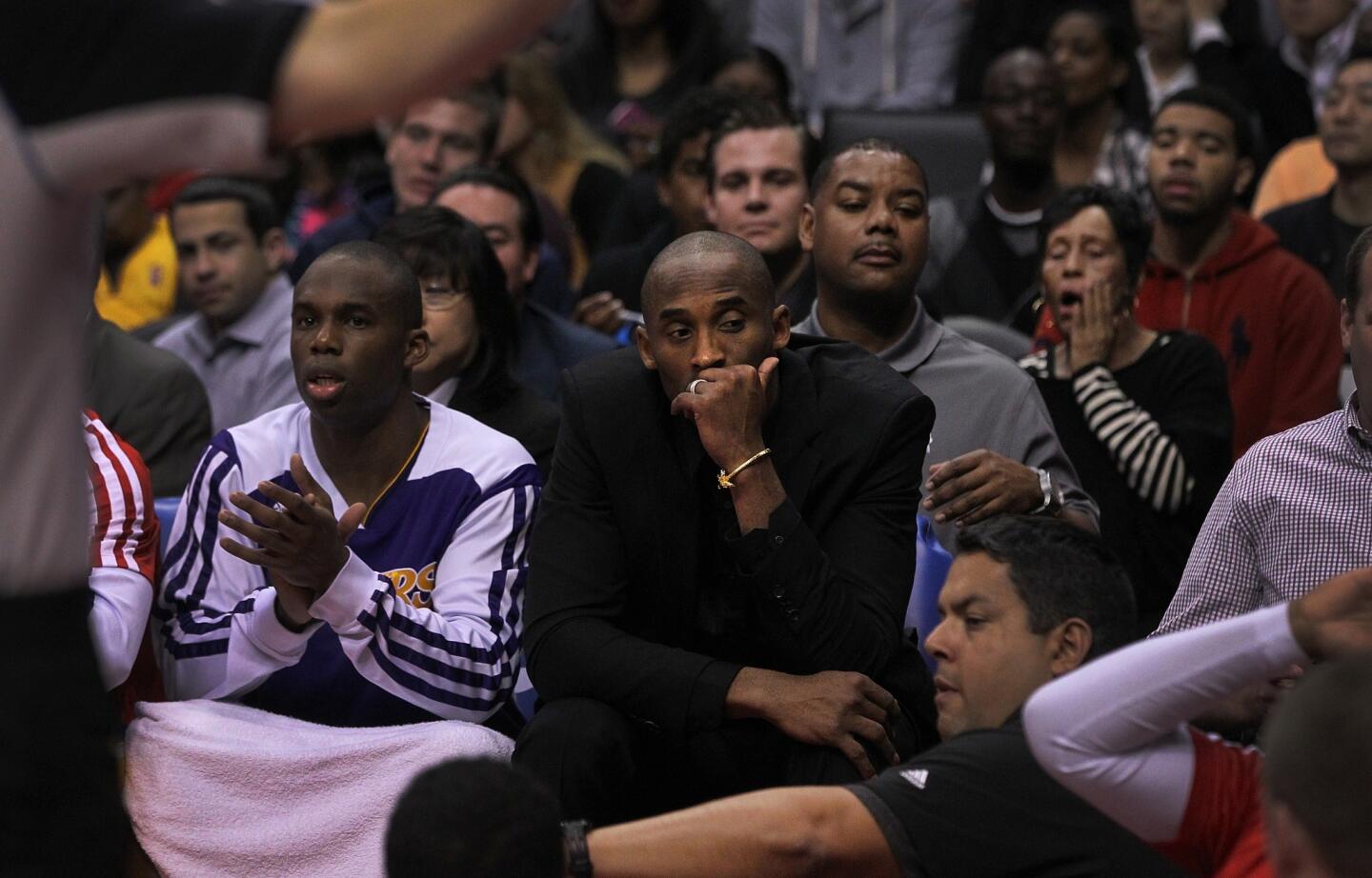 Injured Kobe Bryant looks away from the court during the Clippers' 123-87 rout of the Lakers last Friday at Staples Center.