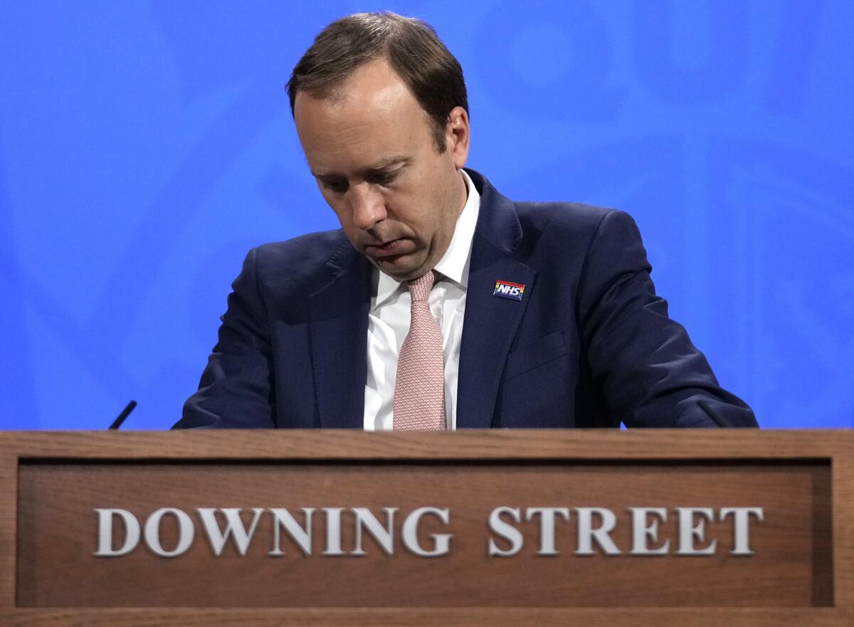 British Health Secretary Matt Hancock behind a lectern that reads "Downing Street."