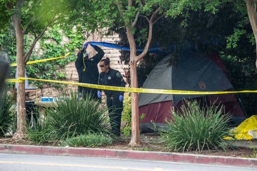 Davis Police investigate on Tuesday, May 2, 2023, the site where a homeless woman was stabbed several times through the side of her tent near Second and L streets before midnight. The city issued issued a shelter in place order that was lifted around 5 a.m.