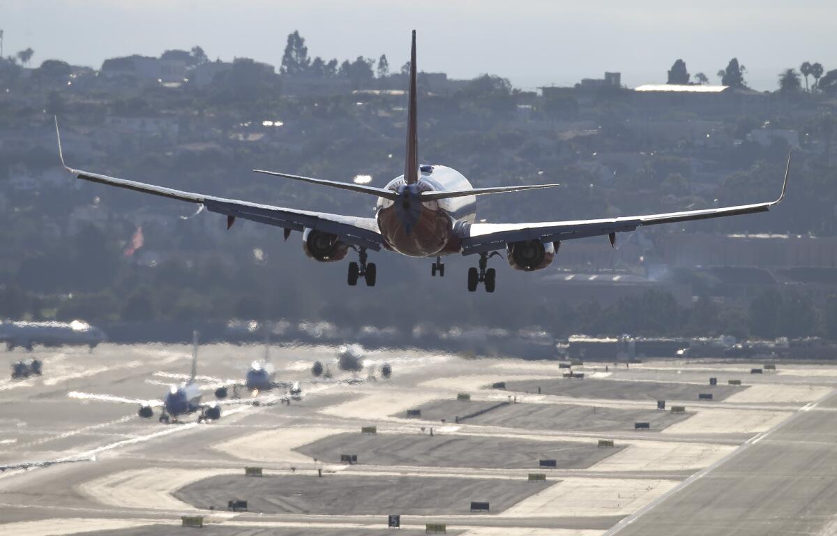 A Southwest Airlines passenger jet lands at San Diego International Airport.