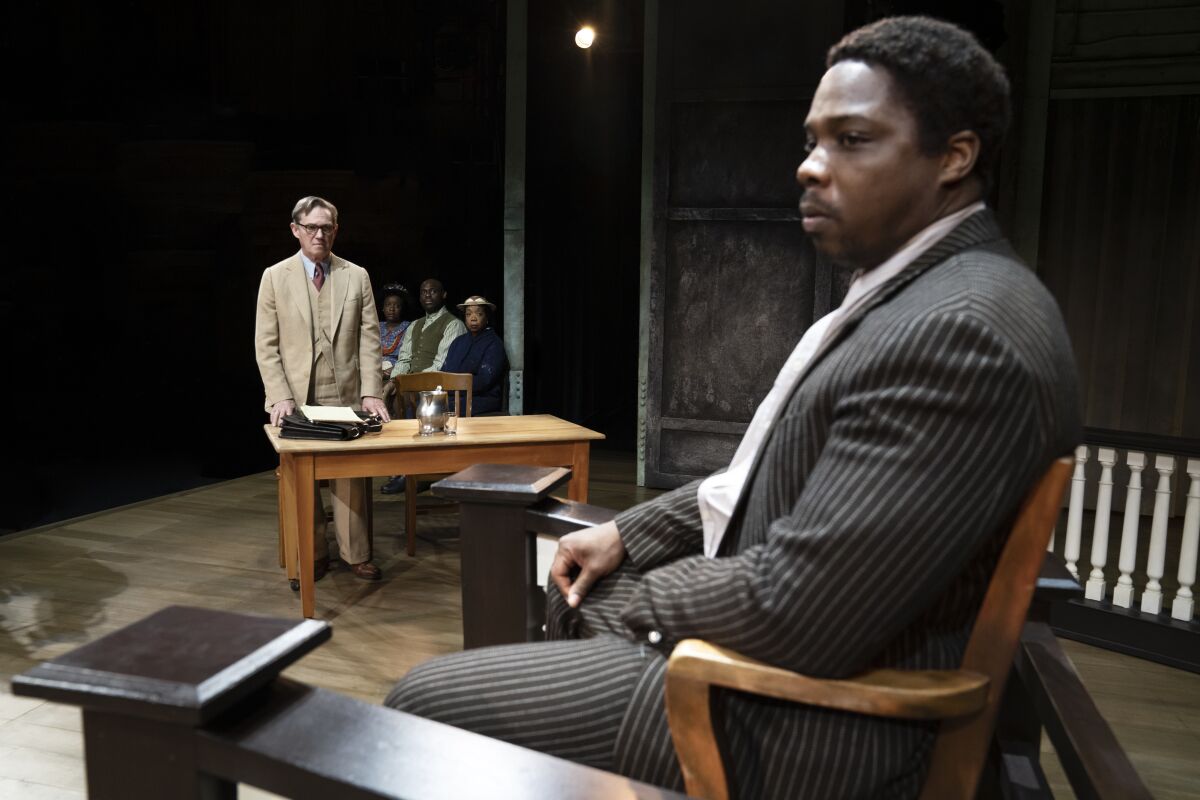 Yaegel T. Welch, foreground, and Rochard Thomas, left, in "To Kill a Mockingbird"