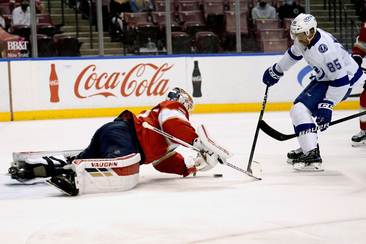 Florida Panthers goaltender Chris Driedger, left, defends the goal against Tampa Bay Lightning's Daniel Walcott (85) during the first period of an NHL hockey game, Monday, May 10, 2021, in Sunrise, Fla. (AP Photo/Lynne Sladky)