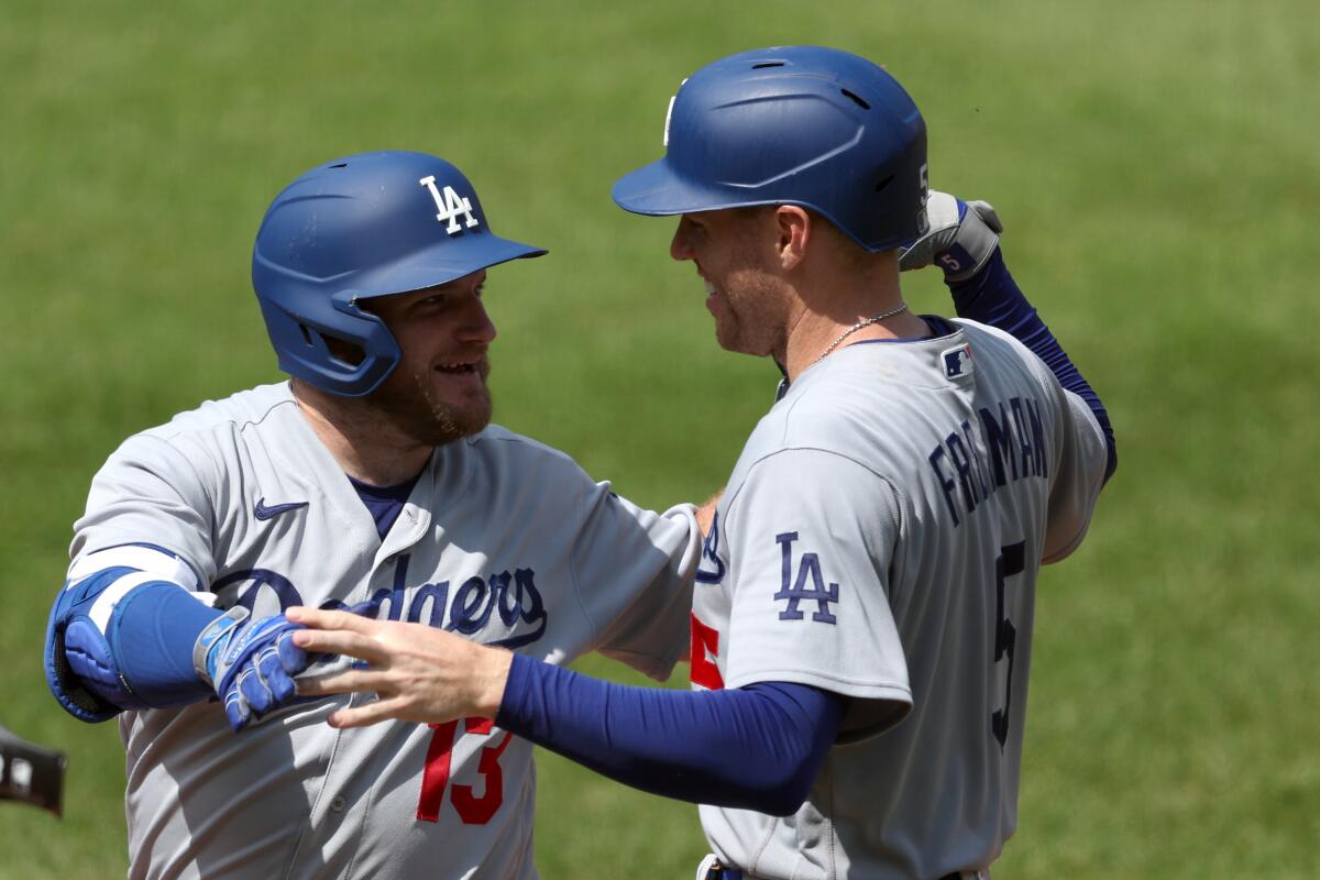 Dodgers' Max Muncy, left, celebrates with Freddie Freeman after hitting a two-run home run against the Baltimore Orioles.