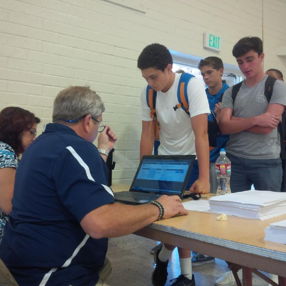 Loyola athletic trainer Tim Moscicki registers students for baseline concussion tests.