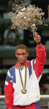 Cuban boxer Joel Casamayor stands on the podium after winning a gold medal at the 1992 Summer Olympics in Barcelona, Spain.