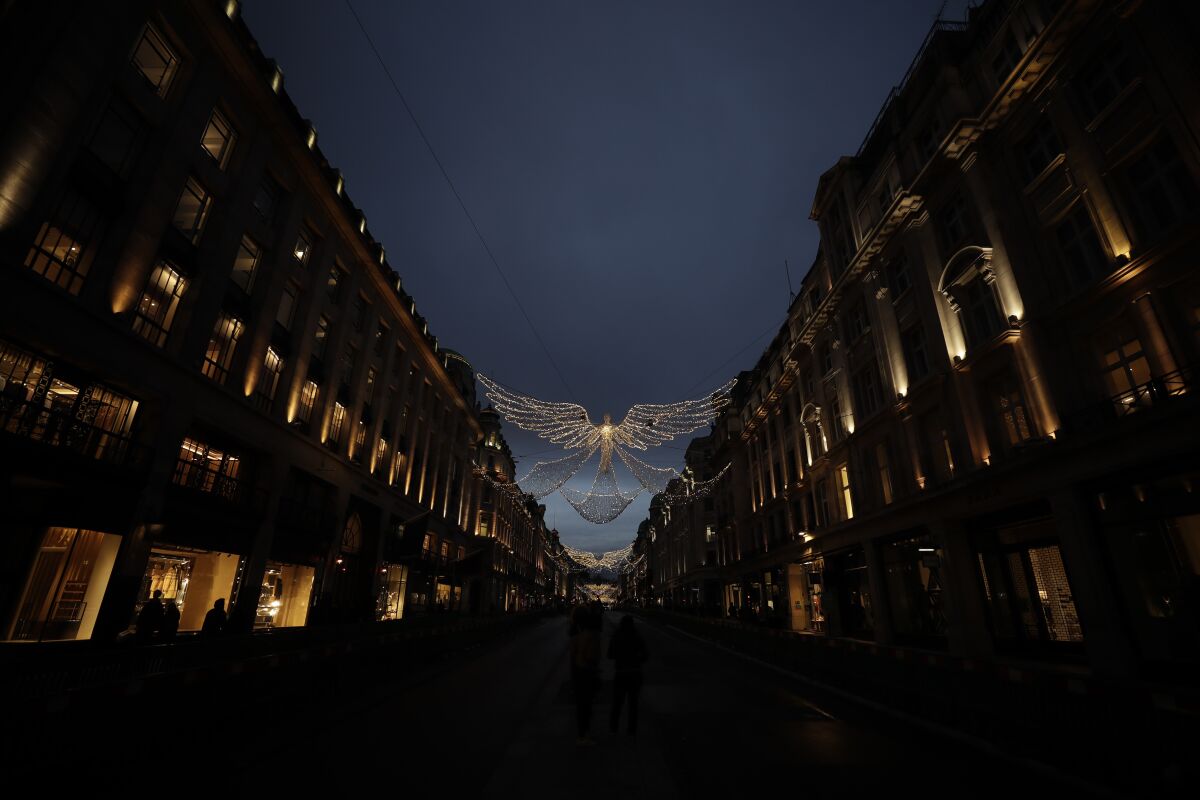 The Regent Street Christmas lights entitled 'The Spirit of Christmas' stand illuminated after being switched on yesterday without a ceremony as shops on the street lie temporarily closed due to England's second coronavirus lockdown, in London, Sunday, Nov. 15, 2020. This week saw Britain on Wednesday become the fifth country in the world to record more than 50,000 coronavirus-related deaths and on Thursday to record 33,470 people testing positive for COVID-19, the highest daily number of new cases since the virus first struck. (AP Photo/Matt Dunham)