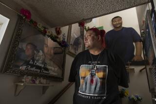 LOS ANGELES, CA-JUNE 4, 2020: Lisa Vargas, the mother of Anthony Vargas, a 21 year old who was shot and killed by L.A. Sheriff's deputies in August of 2018, is photographed next to images of her son, displayed at her home in Los Angeles. Lisa said that her son had no criminal history and is still trying to piece together what happened to her son. Deputies encountered Vargas as they were searching for robbers. They said a scuffle occurred and allege that Vargas had a gun. His mother and many in the community believe the gun was planted. (Mel Melcon/Los Angeles Times)