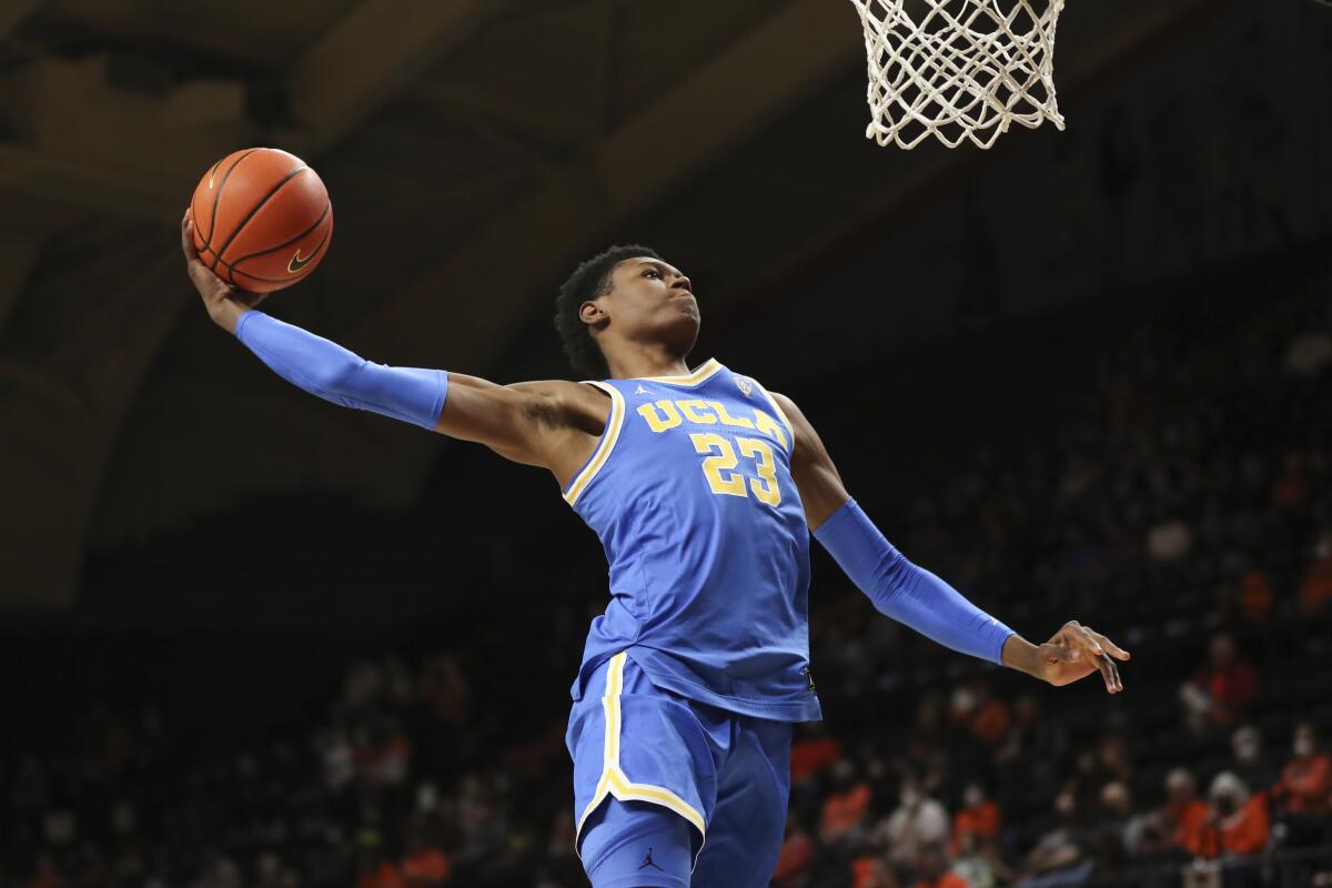 UCLA forward Peyton Watson approaches the rim for a one-handed dunk attempt
