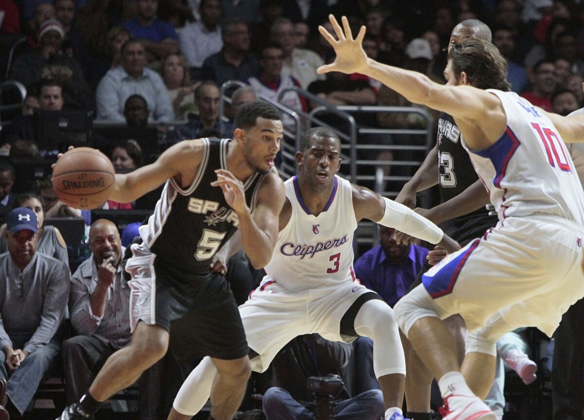 Clippers point guard Chris Paul (3) and forward Spencer Hawes try to trap Spurs guard Cory Joseph in the first half.