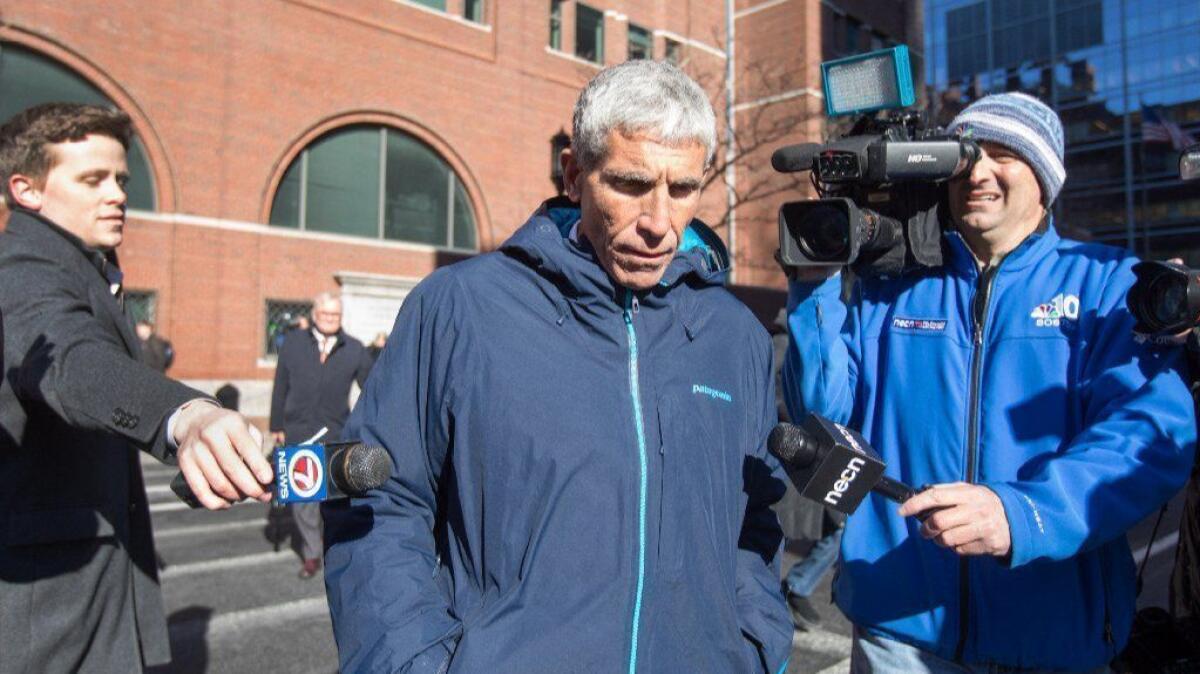 William "Rick" Singer, seen leaving federal court in Boston in March, said in a 2016 deposition he'd served on admissions committees at five universities. The schools have denied it.