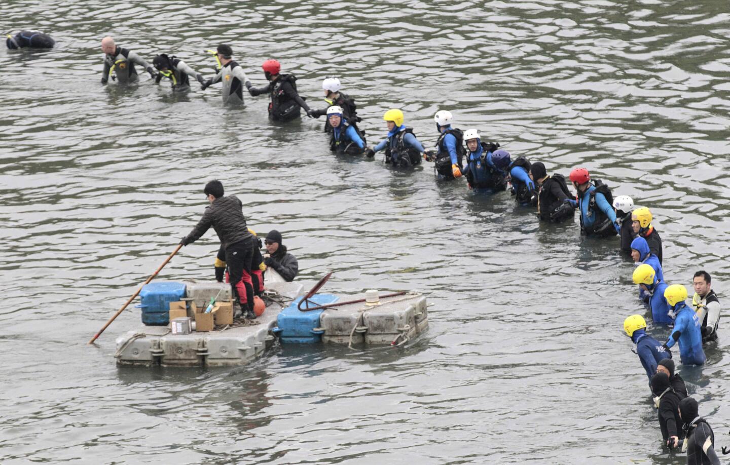 Divers continue to search for the missing at the site of a TransAsia Airways crash in Taipei, Taiwan.