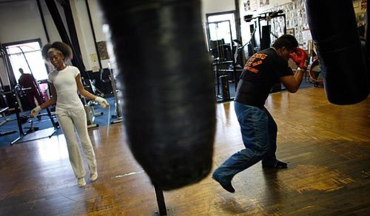 Broadway Gym in Watts has been turning out boxers for more than 30 years. It has seen its ups and downs in the tough neighborhood of South L.A., but like a solid fighter, it has always managed to go the distance. Winter Wyatt, 16, left, skips rope as Alfredo Islas works the heavy bag in the gym. Islas used to box in Mexico and just started hitting the gym after a seven-year absence. More photos >>>