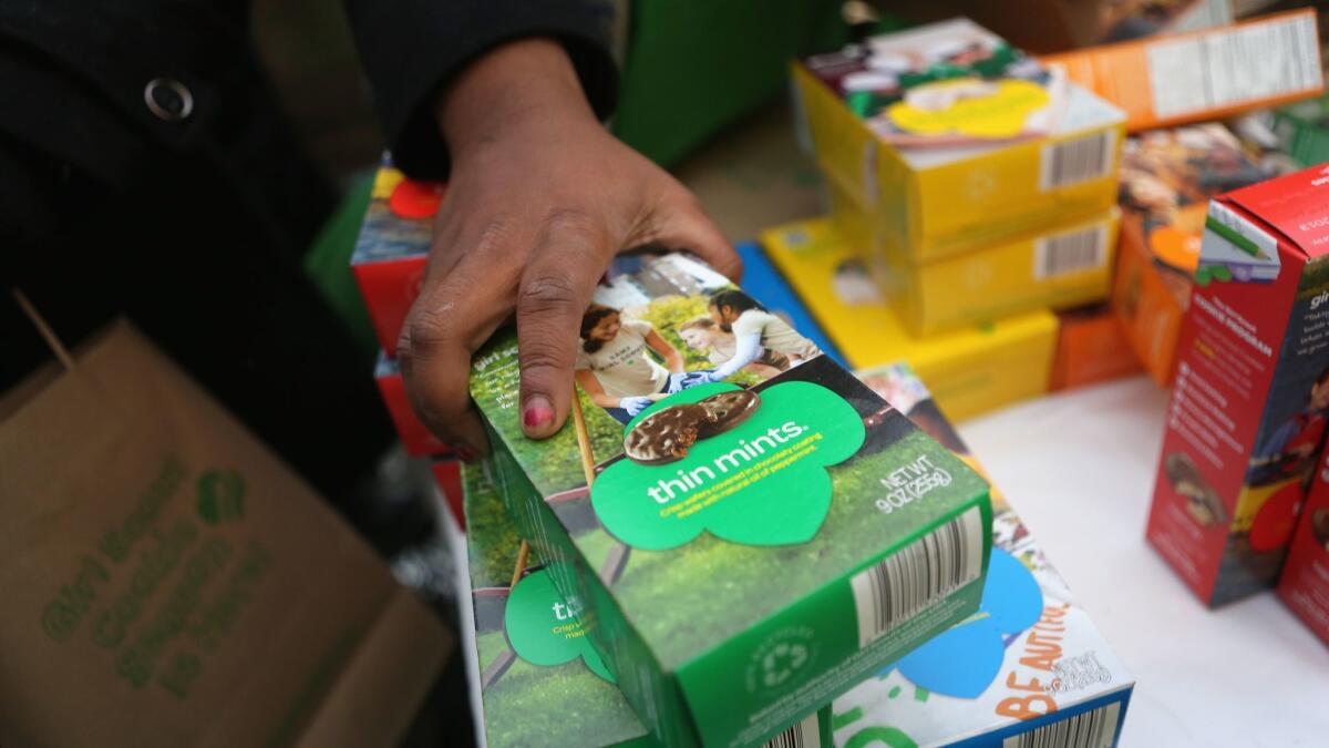 Girl Scouts sell cookies in New York City.