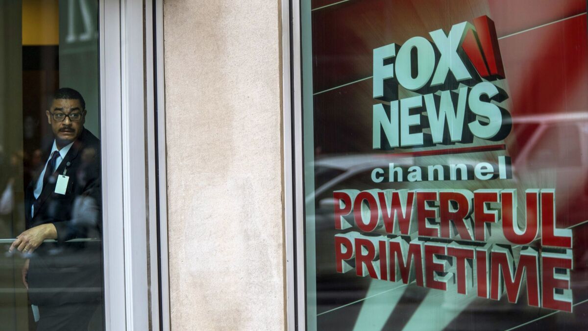 A security guard stands at Fox News studios in New York.