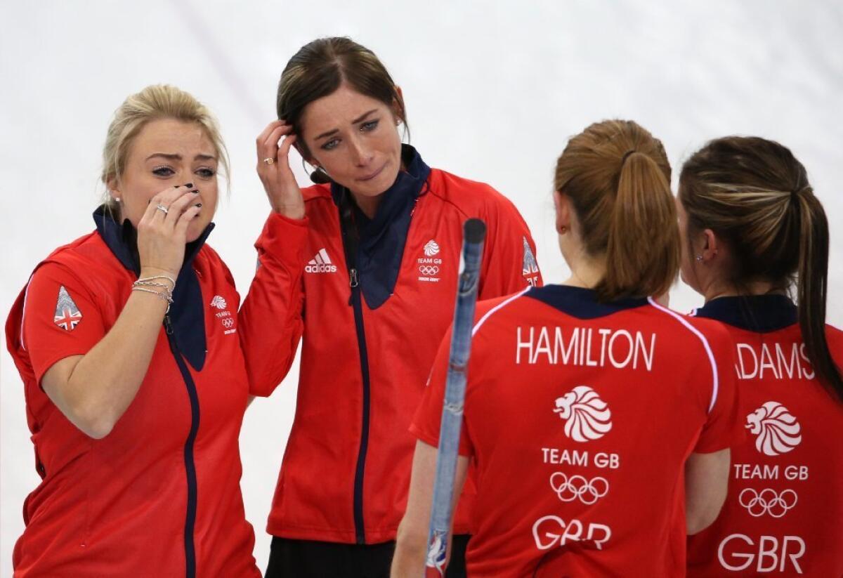 The team from Britain reacts after winning the bronze medal.