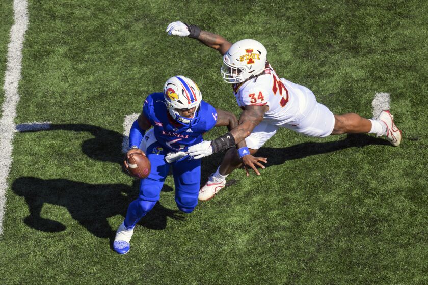 Iowa State linebacker O'Rien Vance (34) pressures Kansas quarterback Jalon Daniels (6) during the first half of an NCAA college football game, Saturday, Oct. 1, 2022, in Lawrence, Kan. (AP Reed/Hoffmann)