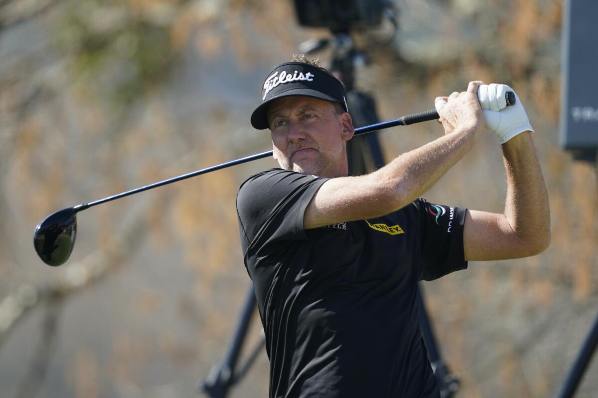 FILE - Ian Poulter watches his shot off the sixth tee during the third round of the Dell Technologies Match Play Championship golf tournament March 25, 2022, in Austin, Texas. Poulter and two other players who signed up for the Saudi-funded LIV Golf series are allowed in the Scottish Open this week. That is after they won a stay Monday, July 4, 2022, from a British court. (AP Photo/Tony Gutierrez, File)