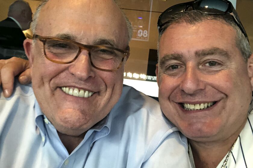 This undated image released by the House Judiciary Committee from documents provided by Lev Parnas to the committee in the impeachment probe against President Donald Trump, shows a photo of Lev Parnas with Rudy Giuliani. Parnas, a close associate of Trump's personal lawyer Giuliani is claiming Trump was directly involved in the effort to pressure Ukraine to investigate Democratic rival Joe Biden. Trump on Thursday, Jan. 16, 2020, repeated denials that he is acquainted with Parnas, despite numerous photos that have emerged of the two men together.(House Judiciary Committee via AP)