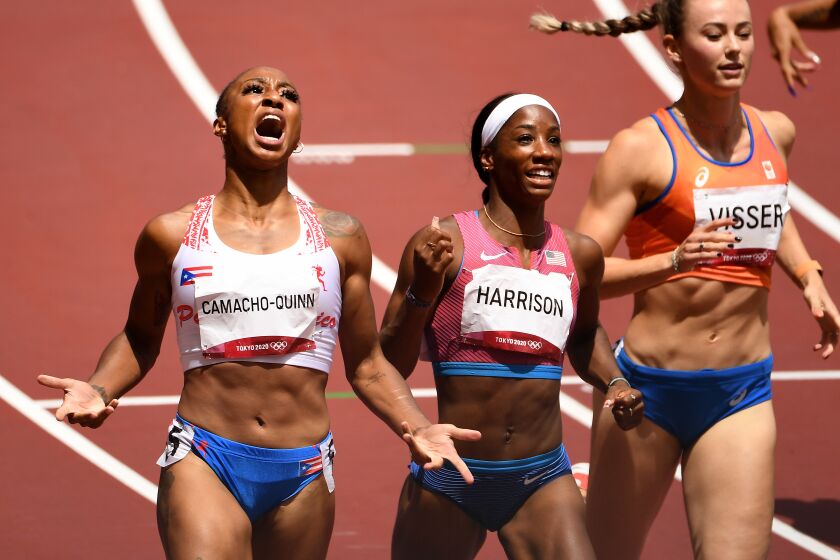 -TOKYO,JAPAN August 2, 2021: Puerto Rico's Jasmine Camacho-Quinn, left, reacts after defeating USA's Kendra Harrison in the 100m hurdles at the 2020 Tokyo Olympics. (Wally Skalij /Los Angeles Times)