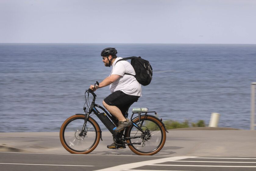 A bicyclist rides along Carlsbad Boulevard at Pine Avenue in Carlsbad during Bike to Work Day 2018.