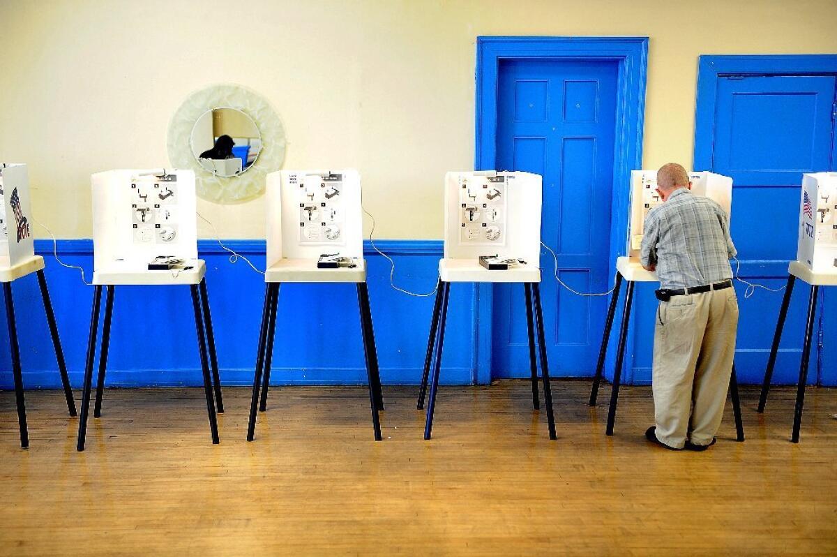 A voter marks his ballot at a South L.A. polling location on election day last November.