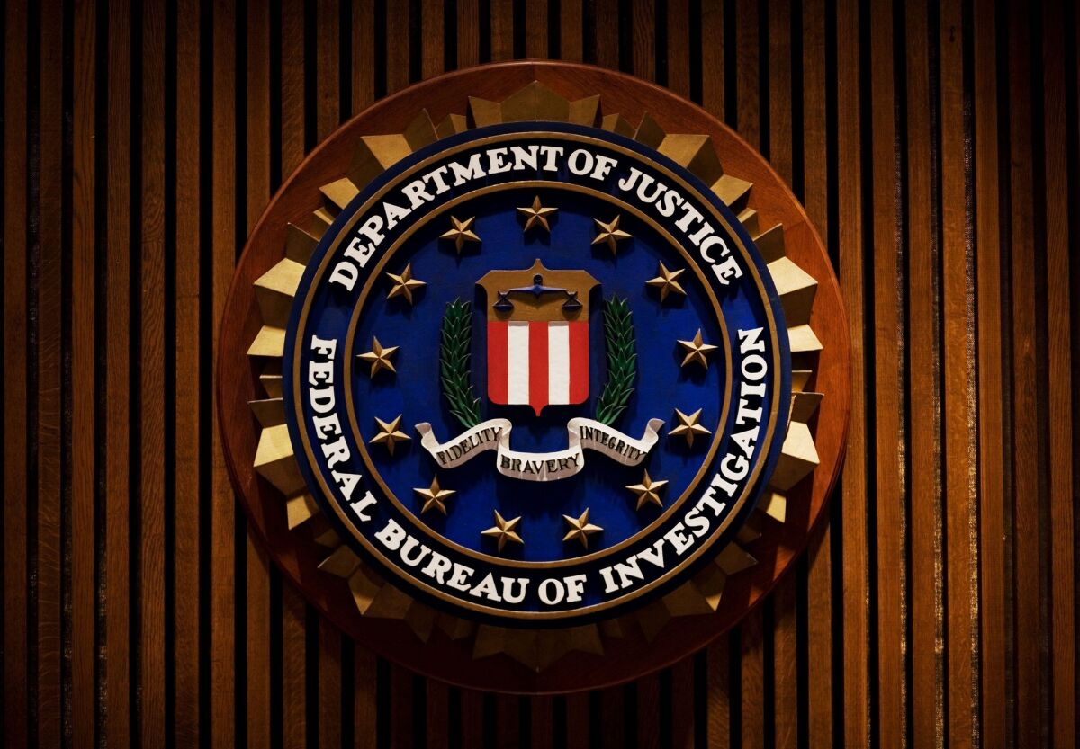 The crest of the FBI inside the J. Edgar Hoover Building in Washington. A former FBI agent has pleaded guilty to stealing more than $100,000 in suspected drug money.