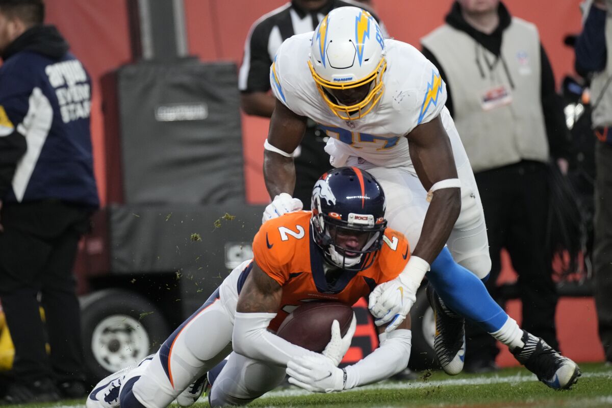 Broncos cornerback Patrick Surtain II (2) intercepts the ball in the end zone in front of  Chargers tight end Jared Cook.