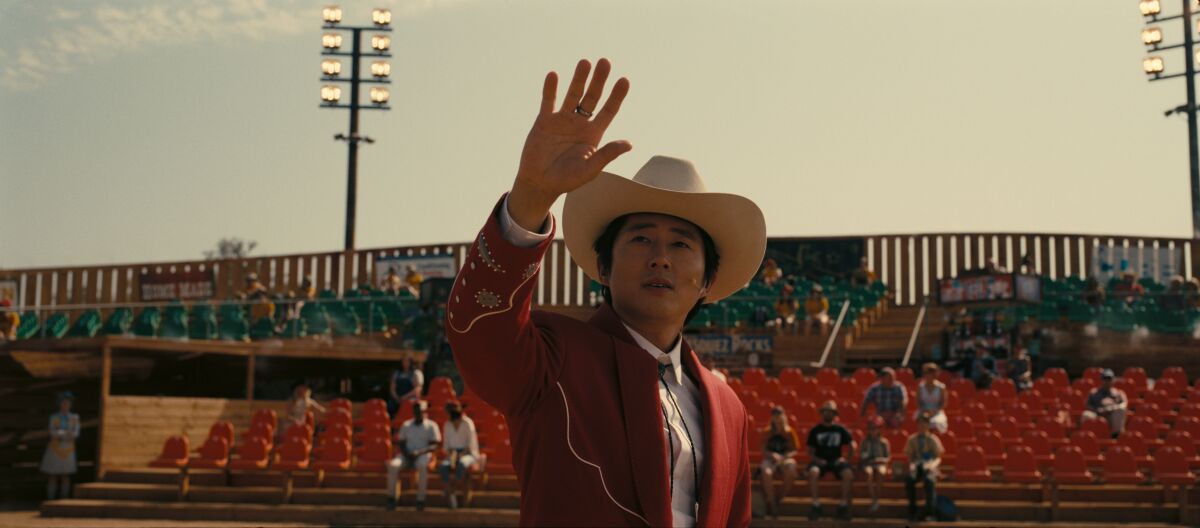 Steven Yeun raises a hand in the movie "Nope."