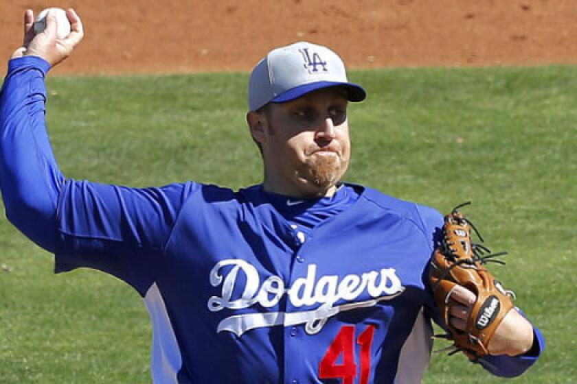 Aaron Harang, shown during a spring training game, is one of three extra starting pitchers the Dodgers had on their opening-day roster.