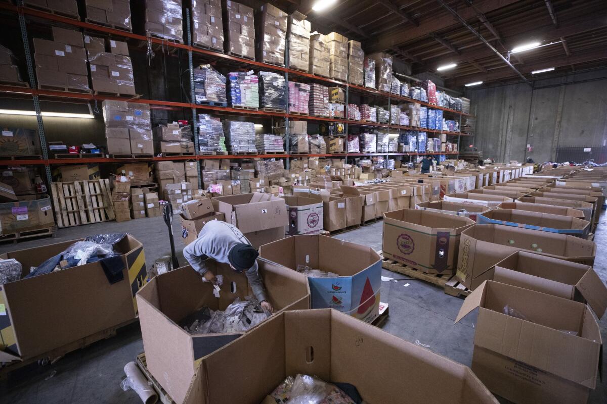 Boxes of goods are sorted in a store's staging area