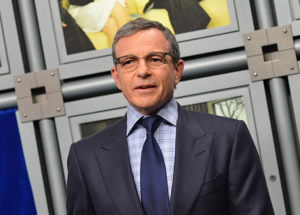 Bob Iger, seen in 2014, announced a "Star Wars" spinoff film's title and a sequel's release date at a Walt Disney Co. shareholders meeting.