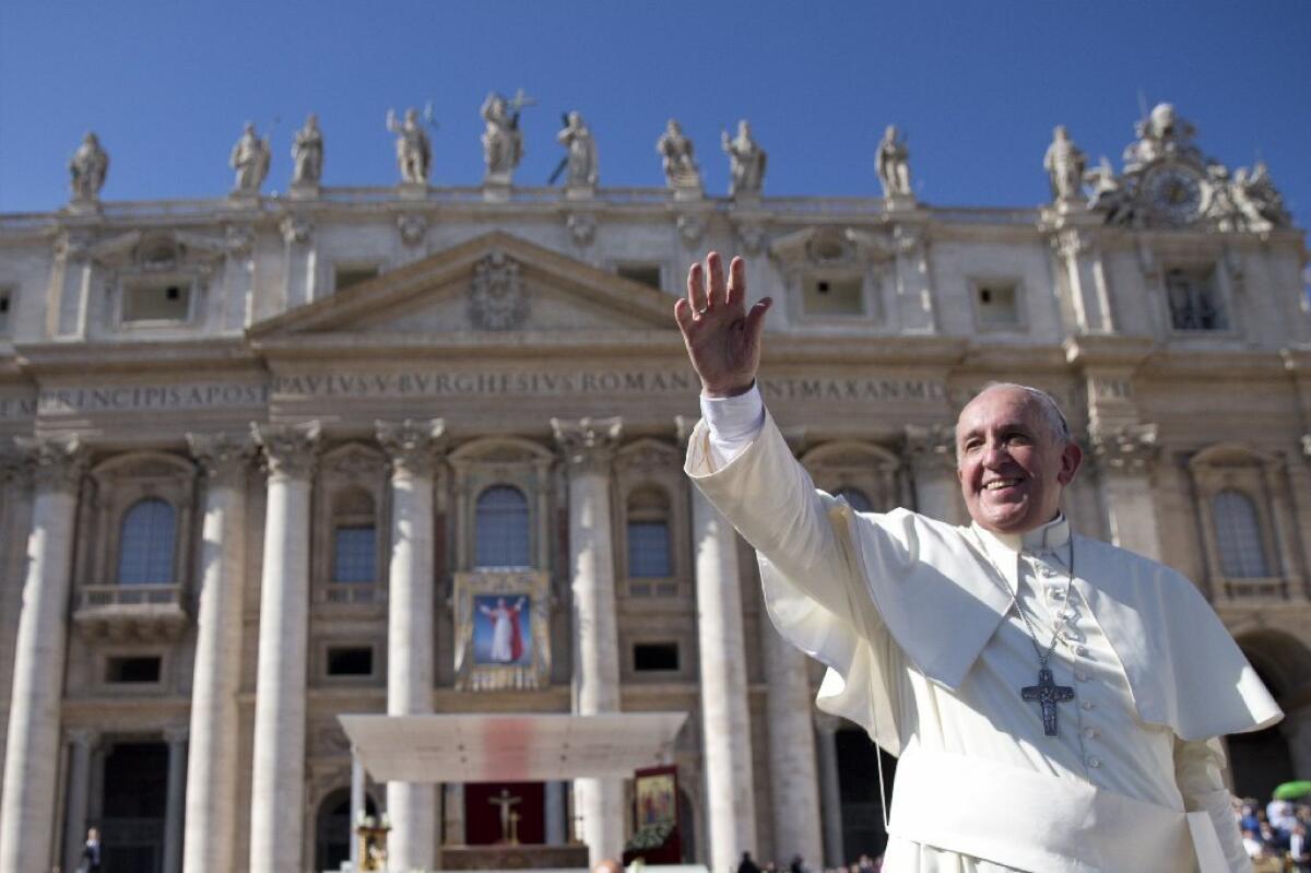 Pope Francis waves after the closing of a synod on family issues at the Vatican.